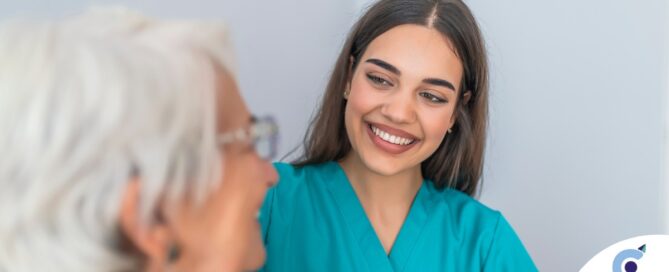 A caregiver smiles with an older client showing the results of successfully starting a new caregiving job.