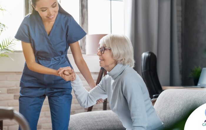 A caregiver demonstrates her caregiver skills by helping an older adult get up.