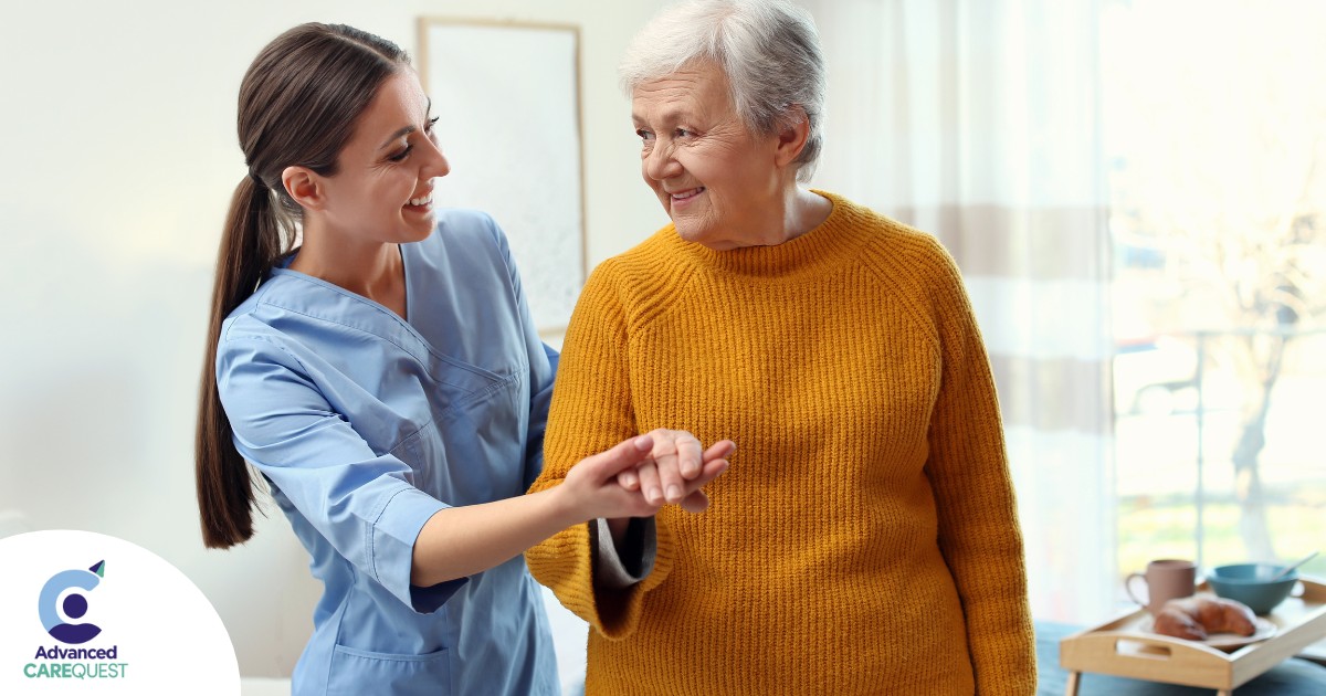 A caregiver helps a client get around, demonstrating one of the job duties of a caregiver.