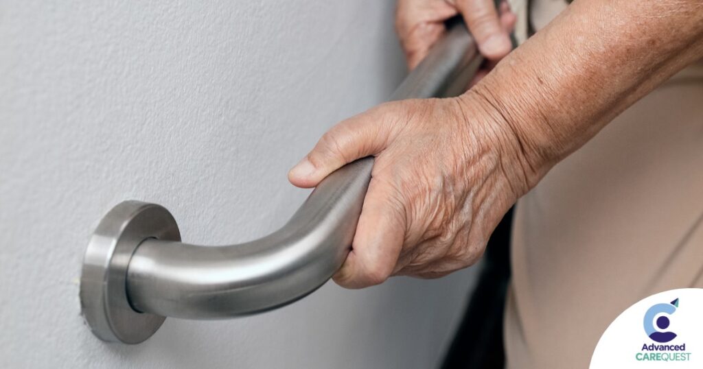 An older adult uses a grab bar representing one of the home modifications that is helpful for fall prevention for elderly adults.