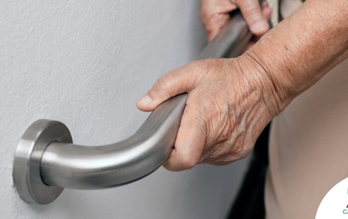 An older adult uses a grab bar representing one of the home modifications that is helpful for fall prevention for elderly adults.