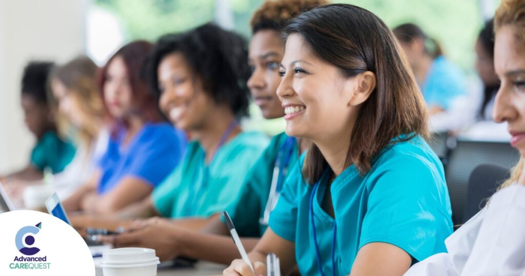 Several students in scrubs happily attend a class, representing caregiver training.