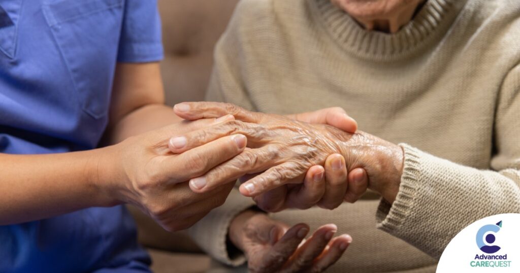 A care provider examines an older adult’s fingers, representing what would happen in an examination for rheumatoid arthritis.