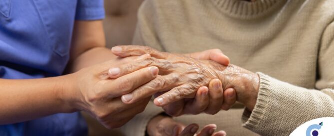 A care provider examines an older adult’s fingers, representing what would happen in an examination for rheumatoid arthritis.